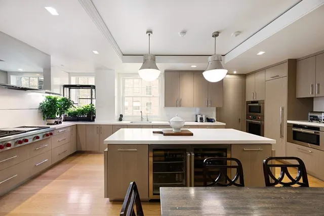 a dining room with furniture a chandelier and wooden floor