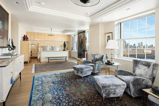 a kitchen with kitchen island granite countertop a sink a counter space appliances and cabinets