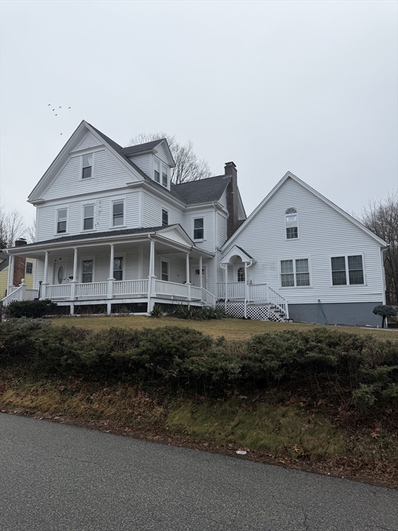 18 Avon Street, Unit B Reading, MA 01867 - Photo 1 of 14 a front view of a house with a garden