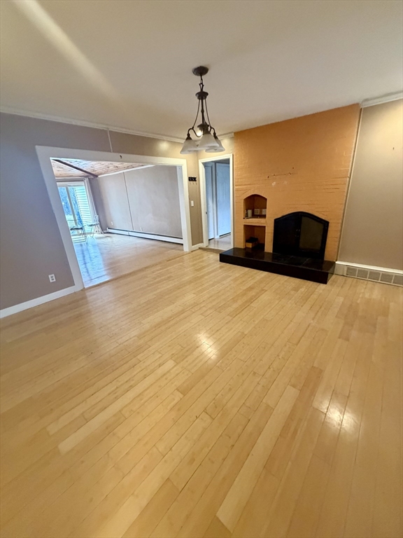 18 Avon Street, Unit B Reading, MA 01867 - Photo 3 of 14 a bedroom with a bed and a chandelier