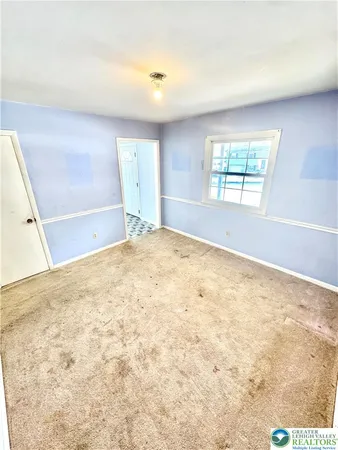 a large white kitchen with granite countertop a sink