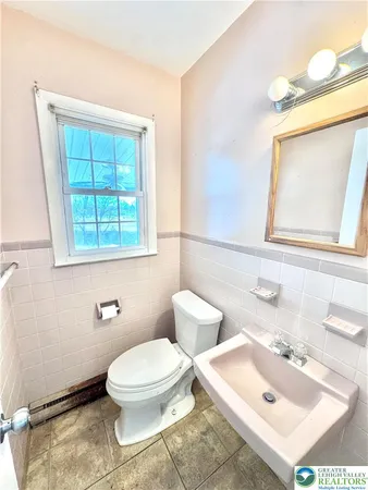 a spacious bathroom with a granite countertop sink and a mirror