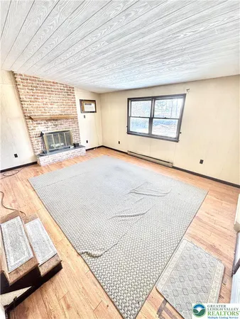 a view of a room with wooden floor and cabinet