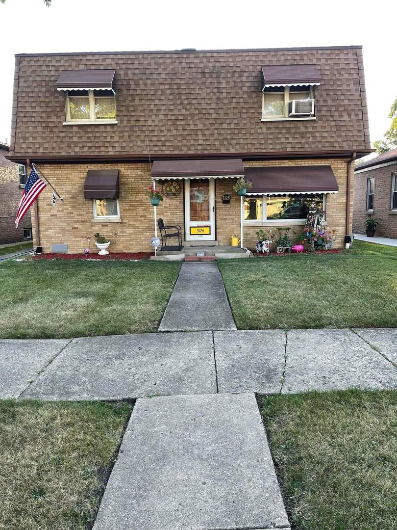 3126 George Street Franklin Park, IL 60131 - Photo 1 of 43 a front view of a house with a garden and trees