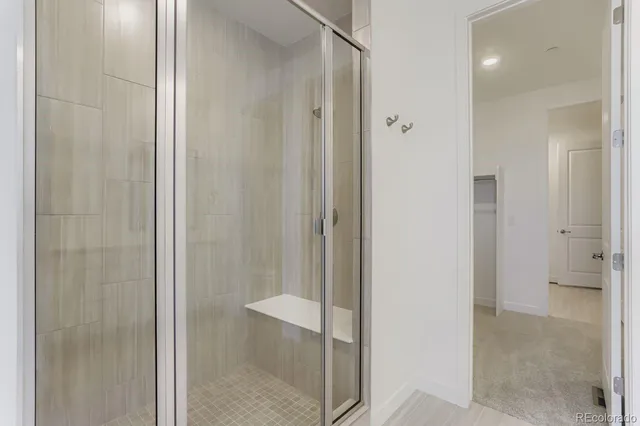 a bathroom with a shower and a glass door