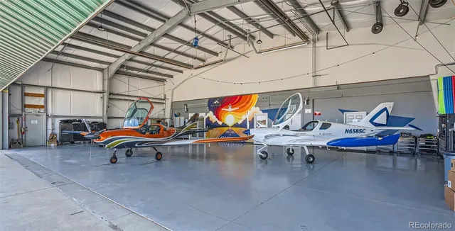 a front view of a house with glass windows and a tree