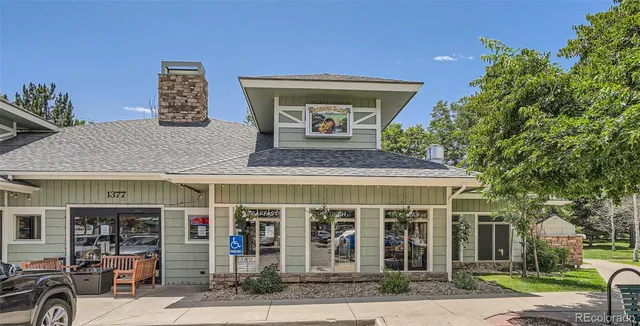 a backyard of a house with table and chairs plants