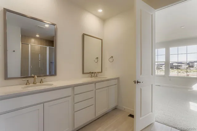 a bathroom with double sink and a mirror