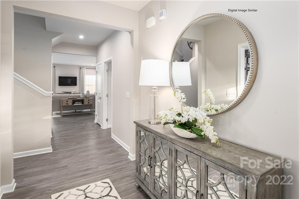 3032 Ballester Road, Unit 250 Indian Land, SC 29707 - Photo 6 of 18 a hallway with wooden floor and dining table