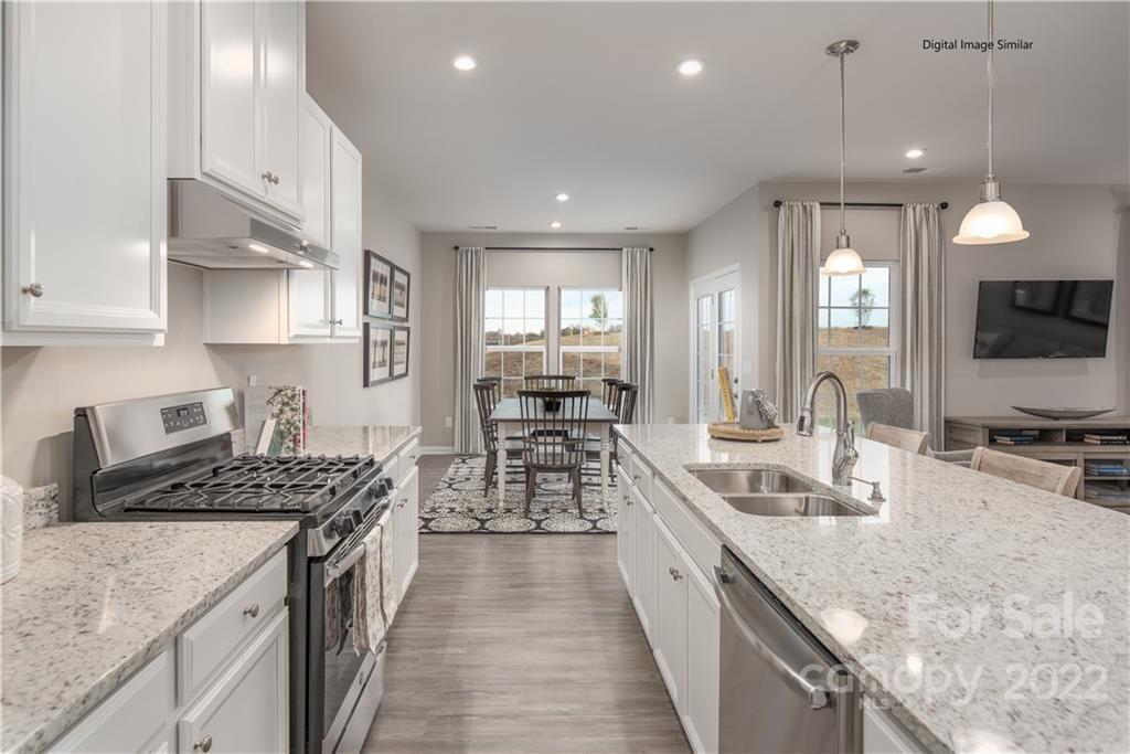3032 Ballester Road, Unit 250 Indian Land, SC 29707 - Photo 8 of 18 a kitchen with counter top space a sink stainless steel appliances and cabinets