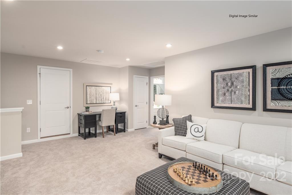 3032 Ballester Road, Unit 250 Indian Land, SC 29707 - Photo 10 of 18 a living room with furniture and a dining table with kitchen view