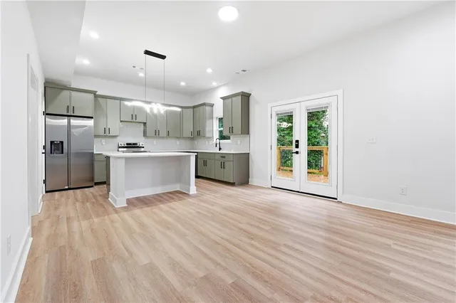 a view of kitchen with stainless steel appliances refrigerator microwave and stove