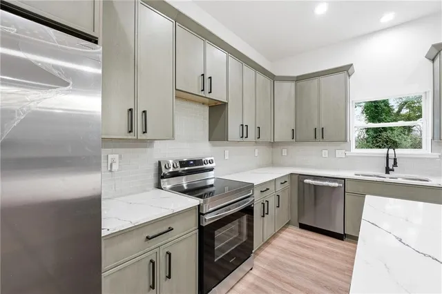 a kitchen with a sink stove and cabinets