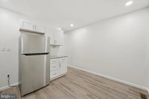 a room with a refrigerator and a sink