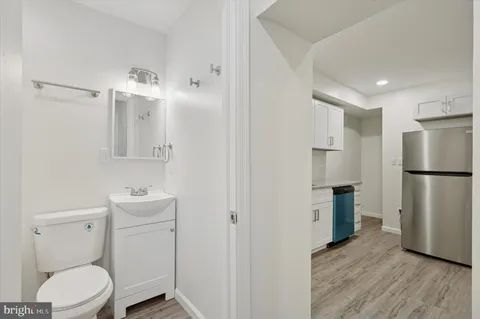 a bathroom with a toilet sink and a mirror