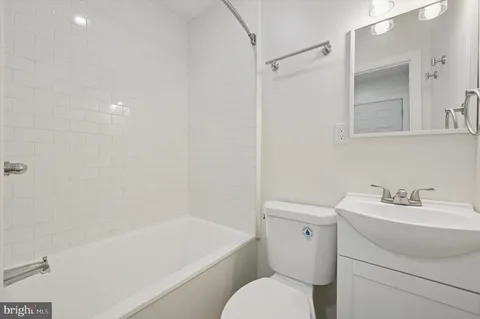 a bathroom with a sink toilet and vanity
