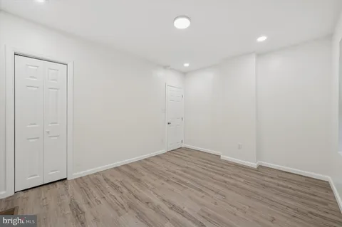 a view of room with wooden floor