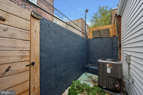 a view of a door and brick wall