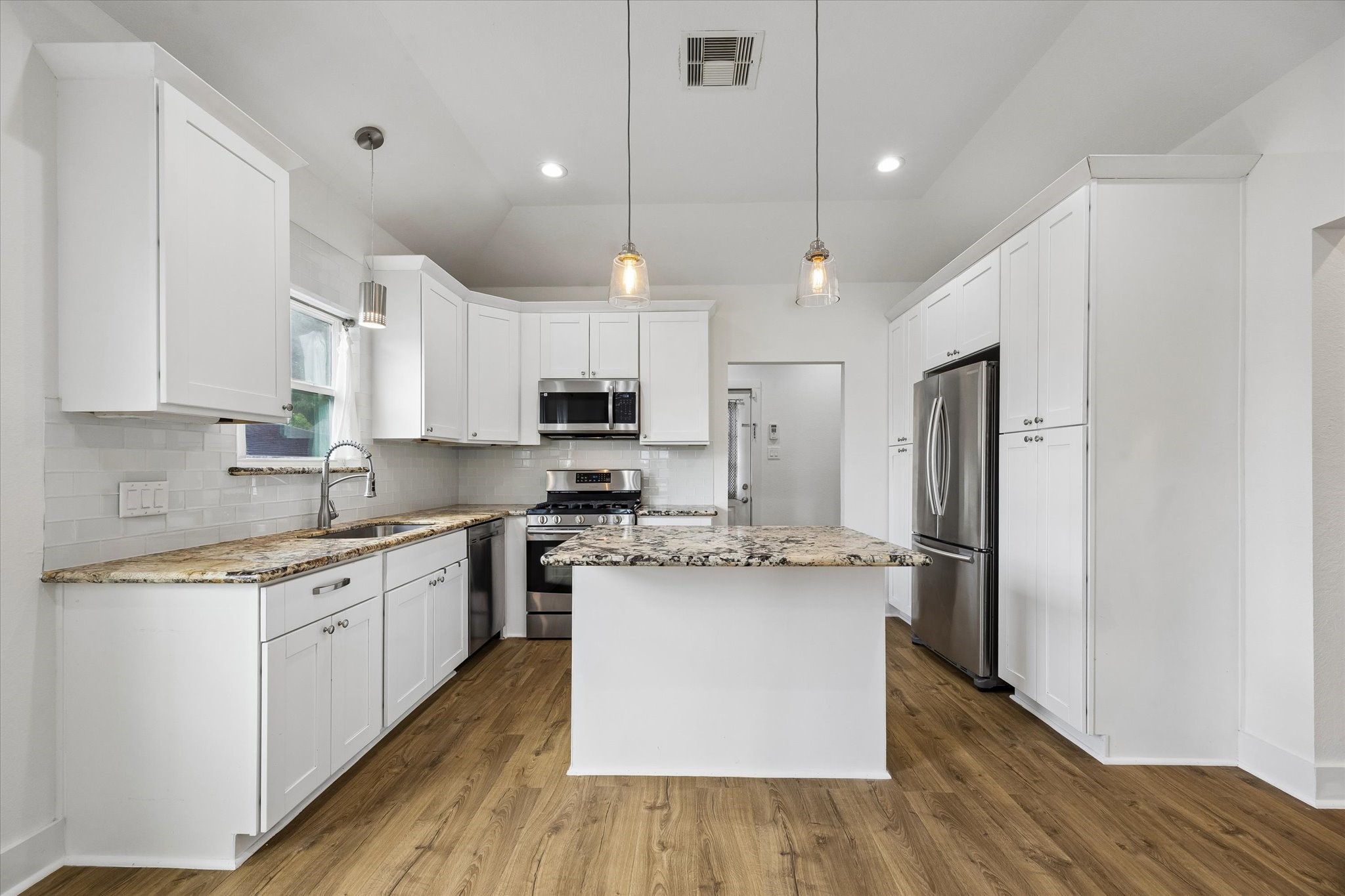 5105 Chapman Street Houston, TX 77009 - Photo 10 of 49 Stunning updated kitchen with island and room for seating at the bar!