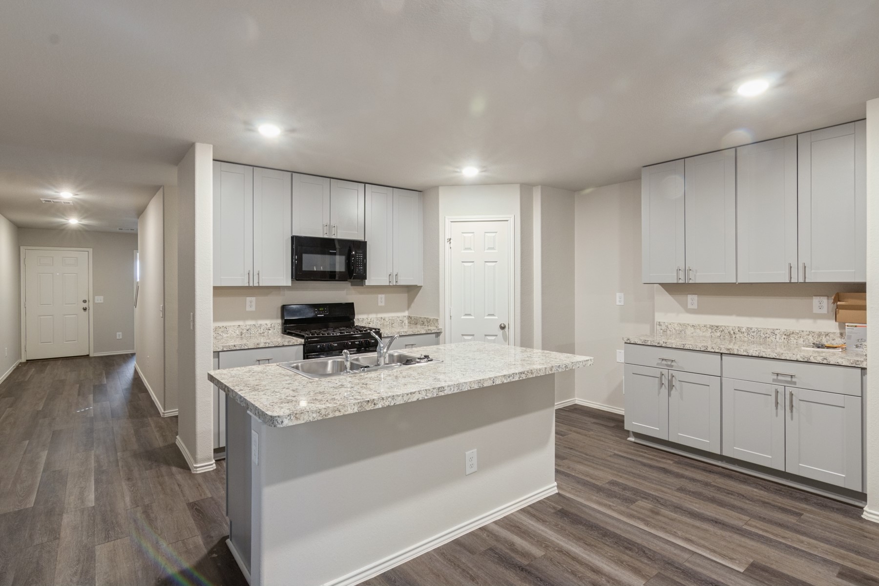 2250 Yelverton Ter Trail Spring, TX 77373 - Photo 13 of 30 a kitchen with a sink stove and microwave