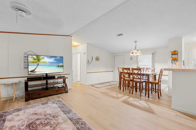 a dining room with furniture and wooden floor