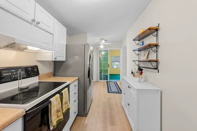 a kitchen with stainless steel appliances granite countertop a stove and a sink