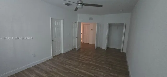 a view of a room with wooden floor and a window