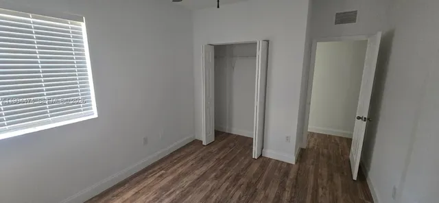 a view of a room with wooden floor