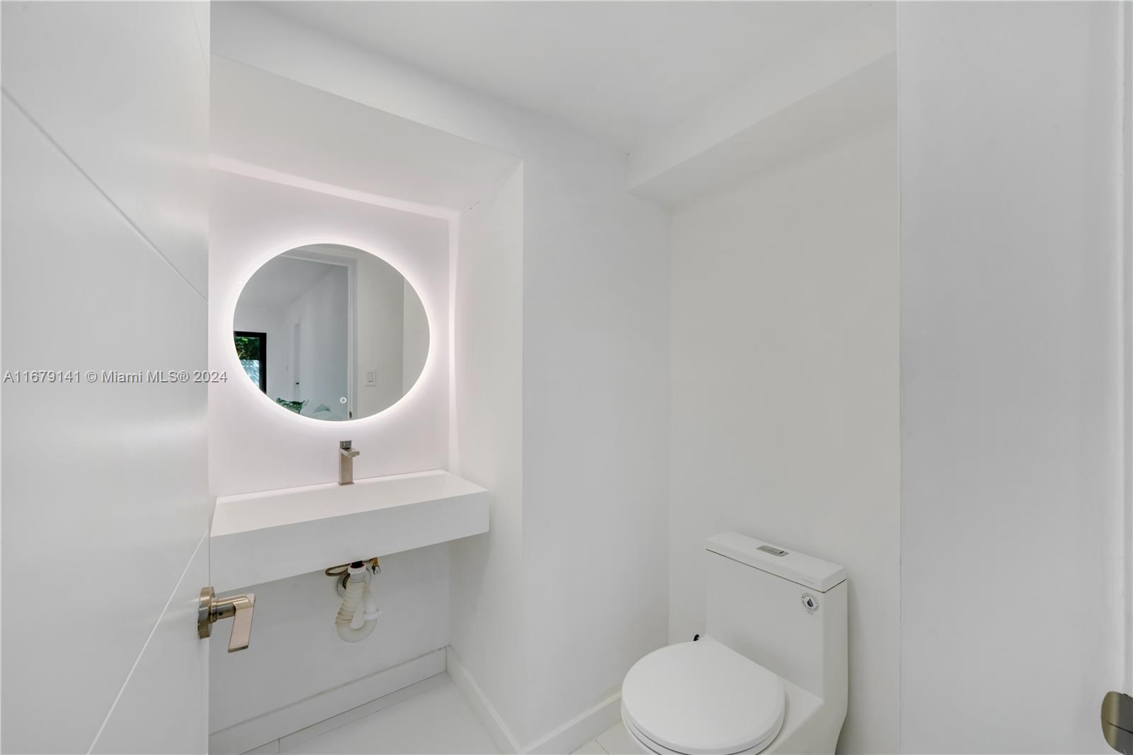 6101 Southwest 44th Terrace Miami, FL 33155 - Photo 11 of 24 a bathroom with a toilet sink a mirror and vanity