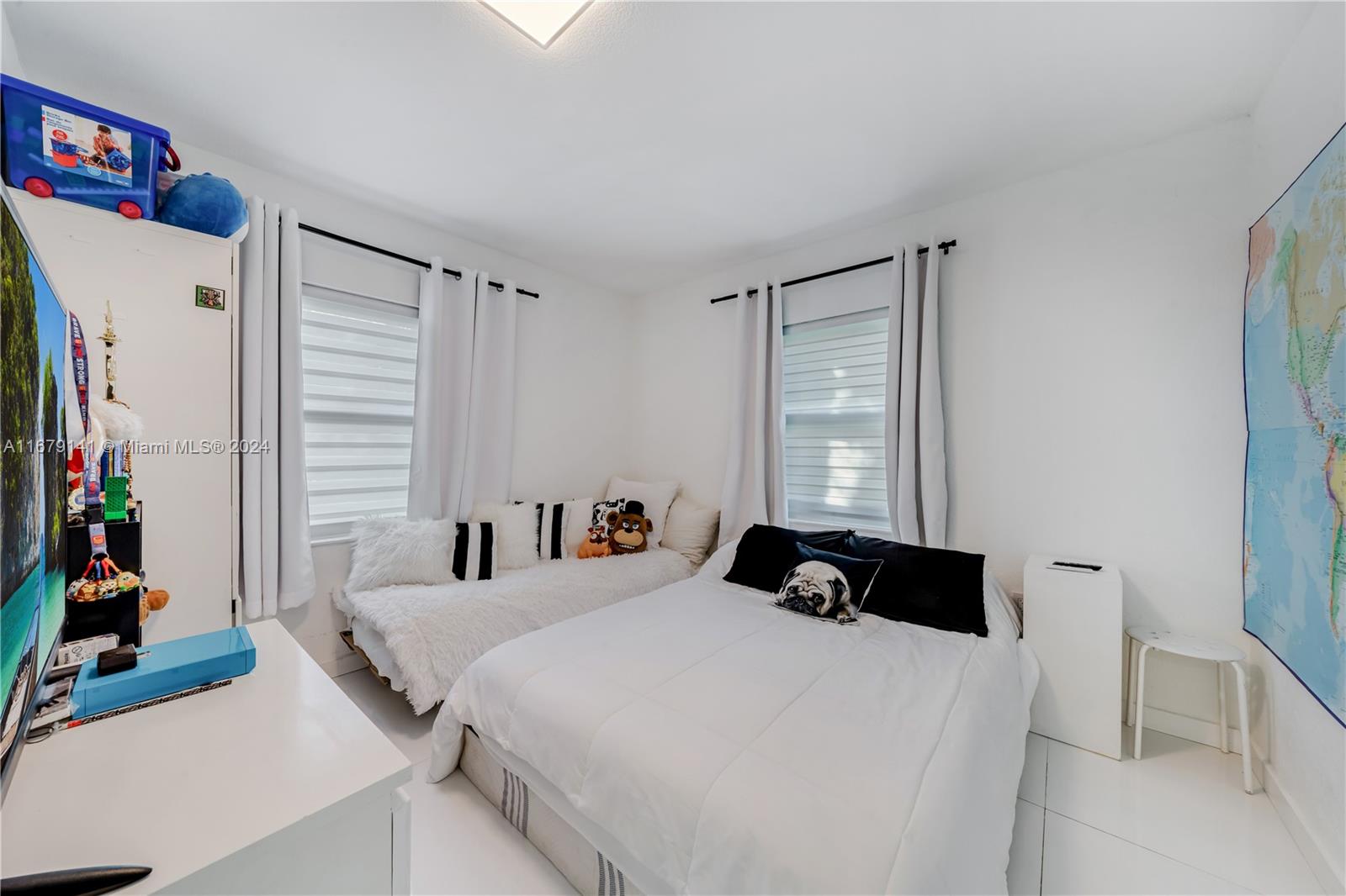6101 Southwest 44th Terrace Miami, FL 33155 - Photo 12 of 24 a bedroom with a bed and a large window