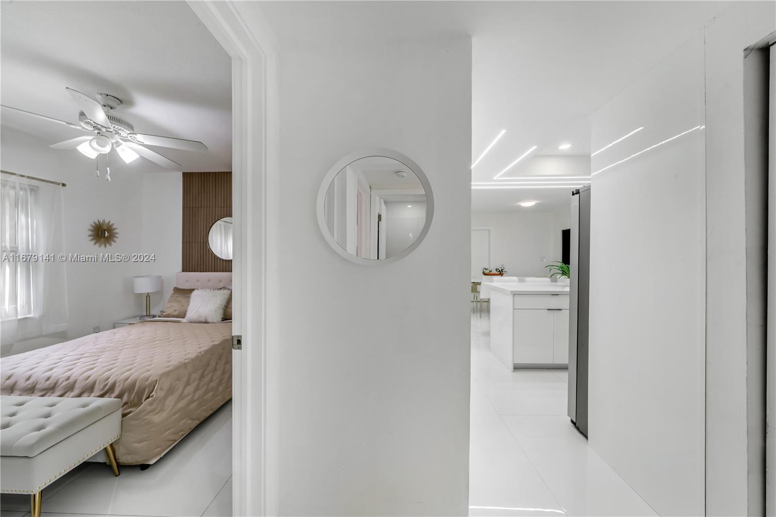 6101 Southwest 44th Terrace Miami, FL 33155 - Photo 13 of 24 a bedroom with a bed a mirror and clock on the wall