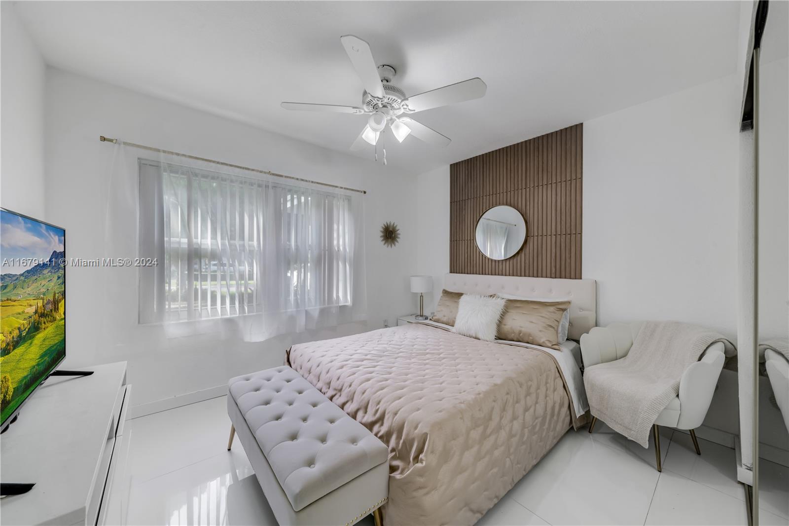 6101 Southwest 44th Terrace Miami, FL 33155 - Photo 15 of 24 a bedroom with a large bed and a chandelier