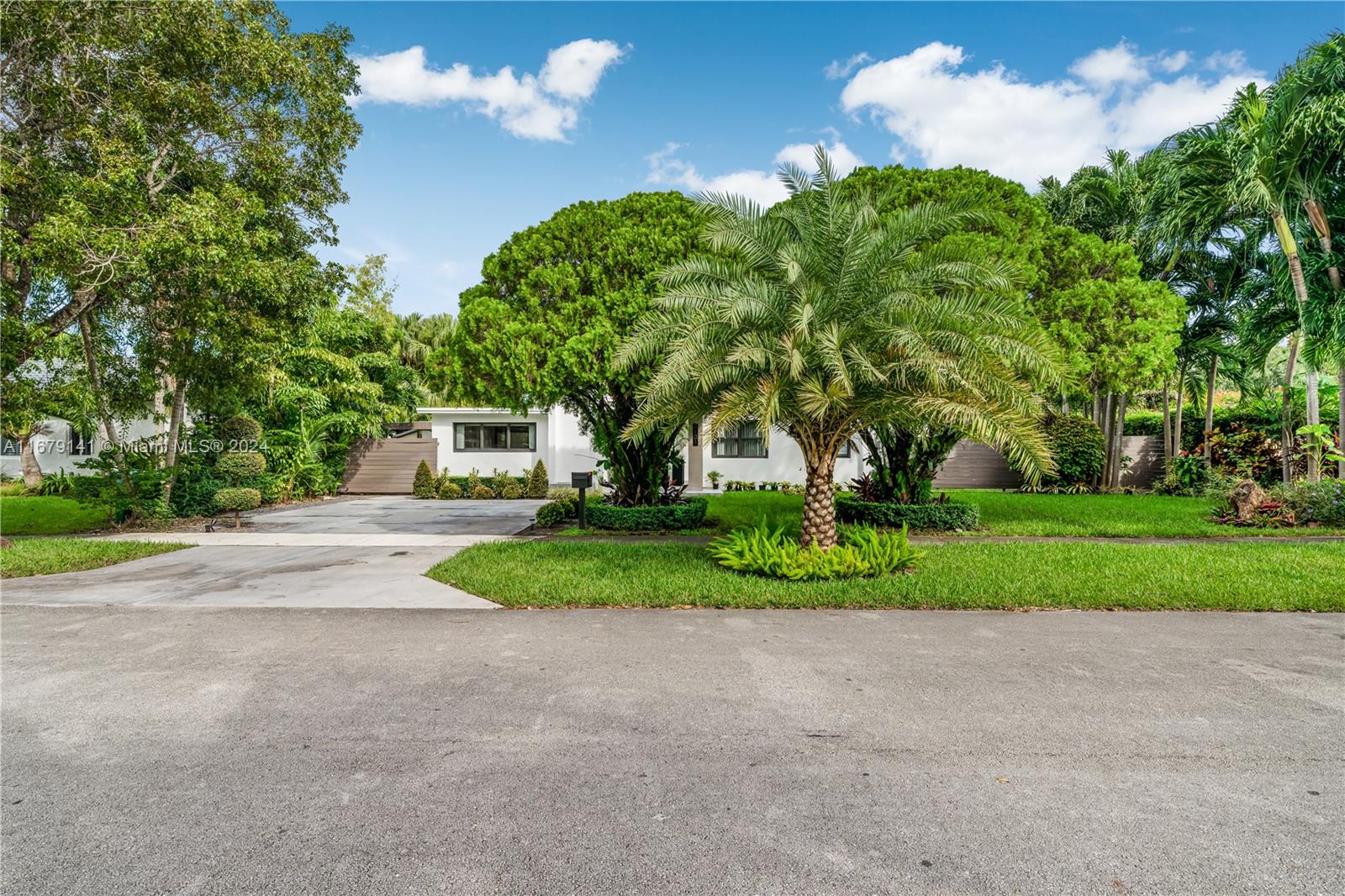 6101 Southwest 44th Terrace Miami, FL 33155 - Photo 2 of 24 a front view of a house with a yard and green space