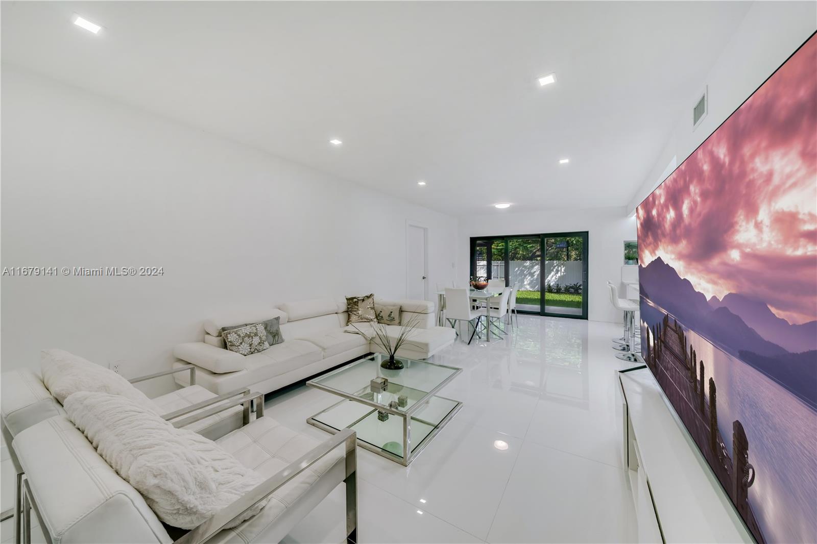 6101 Southwest 44th Terrace Miami, FL 33155 - Photo 7 of 24 a living room with furniture and a flat screen tv