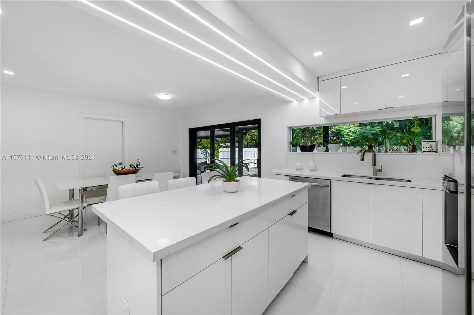 6101 Southwest 44th Terrace Miami, FL 33155 - Photo 8 of 24 a large white kitchen with a sink and cabinets
