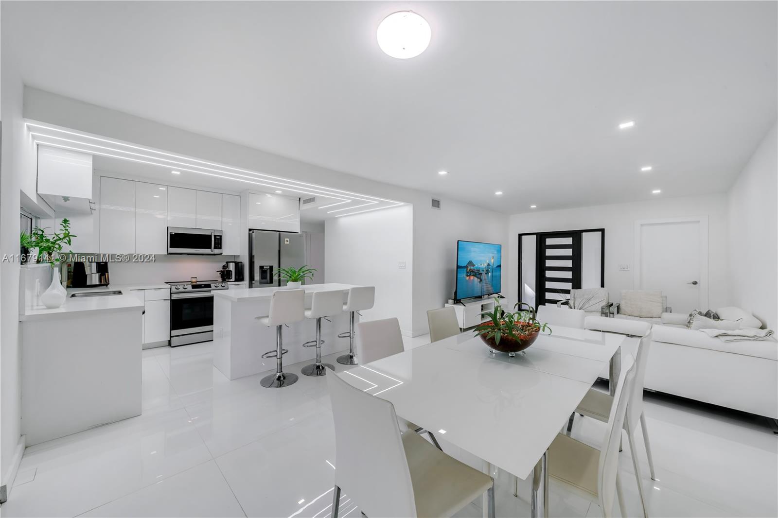 6101 Southwest 44th Terrace Miami, FL 33155 - Photo 9 of 24 a kitchen with a sink a counter and chairs