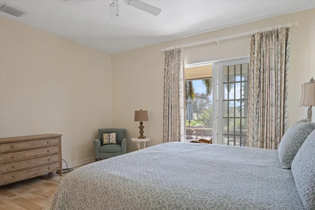 a spacious bedroom with a bed and glass door