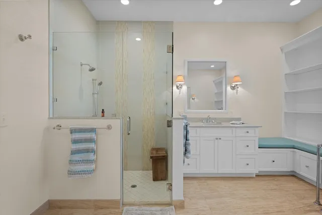 a spacious bathroom with a granite countertop sink a toilet and a mirror