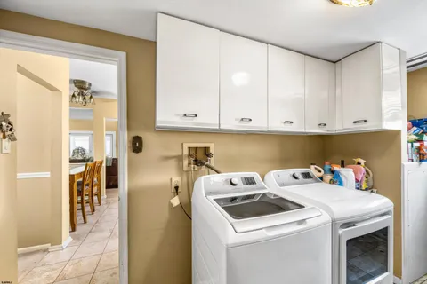 a bedroom with a bed a dresser and chair