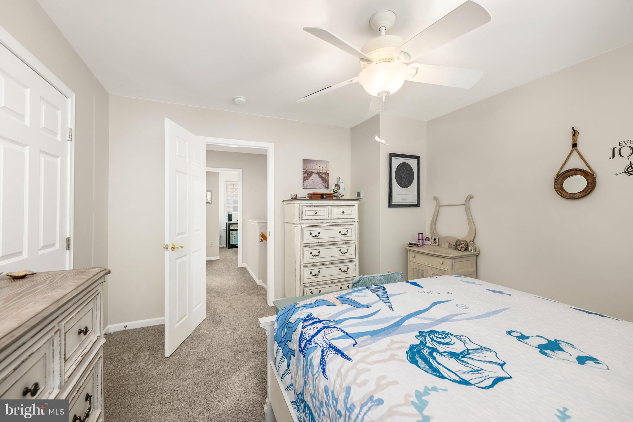 27548 Mayfield Road, Unit 42 Millsboro, DE 19966 - Photo 20 of 46 a bedroom with a bed and a chandelier