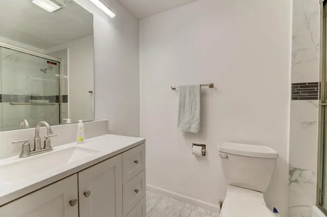 a bathroom with a sink toilet and shower