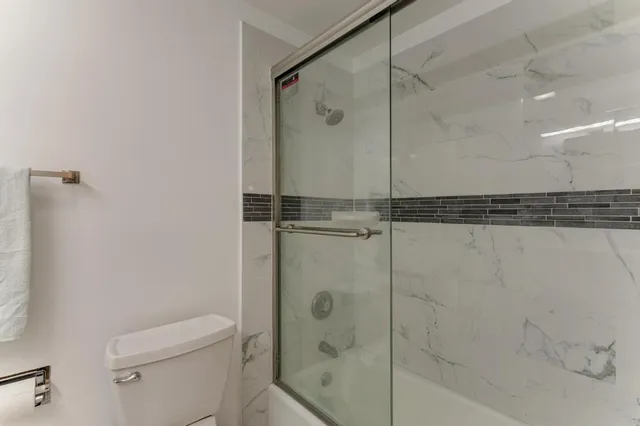 a bathroom with a shower and a toilet