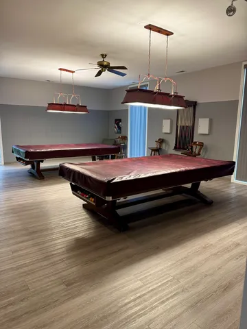 a living room with stainless steel appliances kitchen island furniture and a fireplace