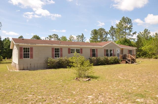 72 Arbour Street DeFuniak Springs, FL 32433 - Photo 1 of 13 front view of a house with a yard