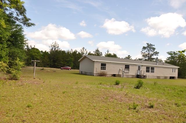 72 Arbour Street DeFuniak Springs, FL 32433 - Photo 12 of 13 a view of a house with a backyard