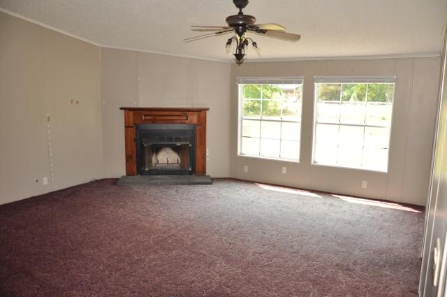 72 Arbour Street DeFuniak Springs, FL 32433 - Photo 3 of 13 a view of an empty room with a fireplace and a window