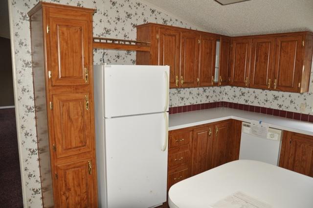 72 Arbour Street DeFuniak Springs, FL 32433 - Photo 4 of 13 a white refrigerator freezer sitting in a kitchen