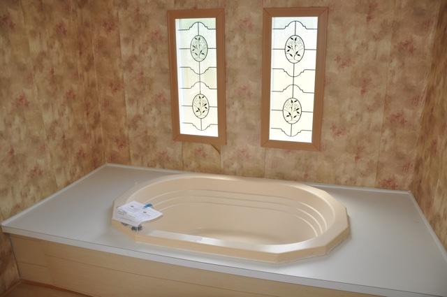 72 Arbour Street DeFuniak Springs, FL 32433 - Photo 8 of 13 a white bath tub sitting in a bathroom