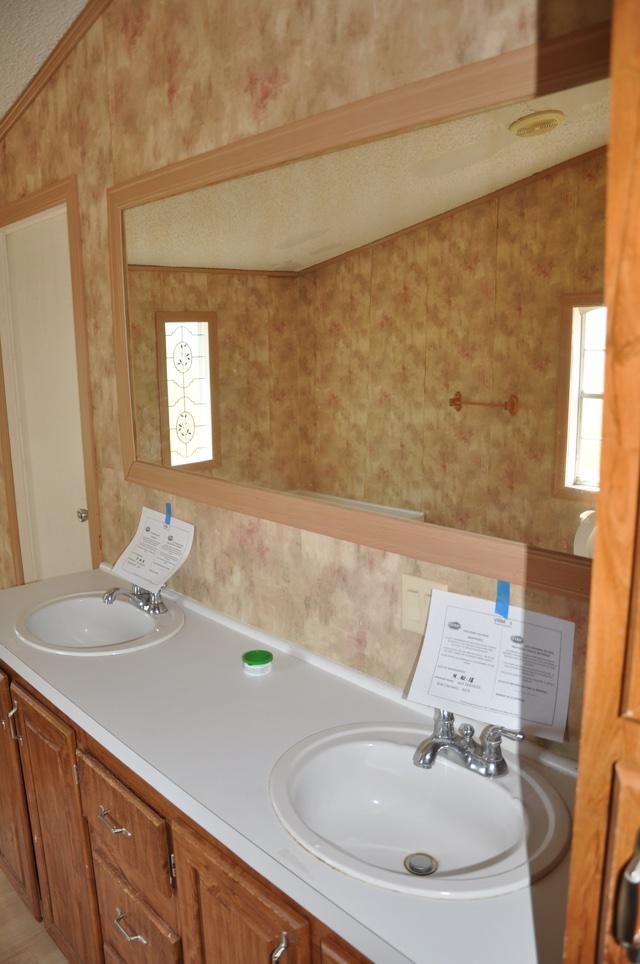 72 Arbour Street DeFuniak Springs, FL 32433 - Photo 9 of 13 a bathroom with a sink and a mirror