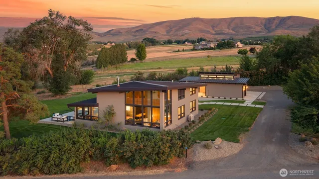 an aerial view of a house with big yard